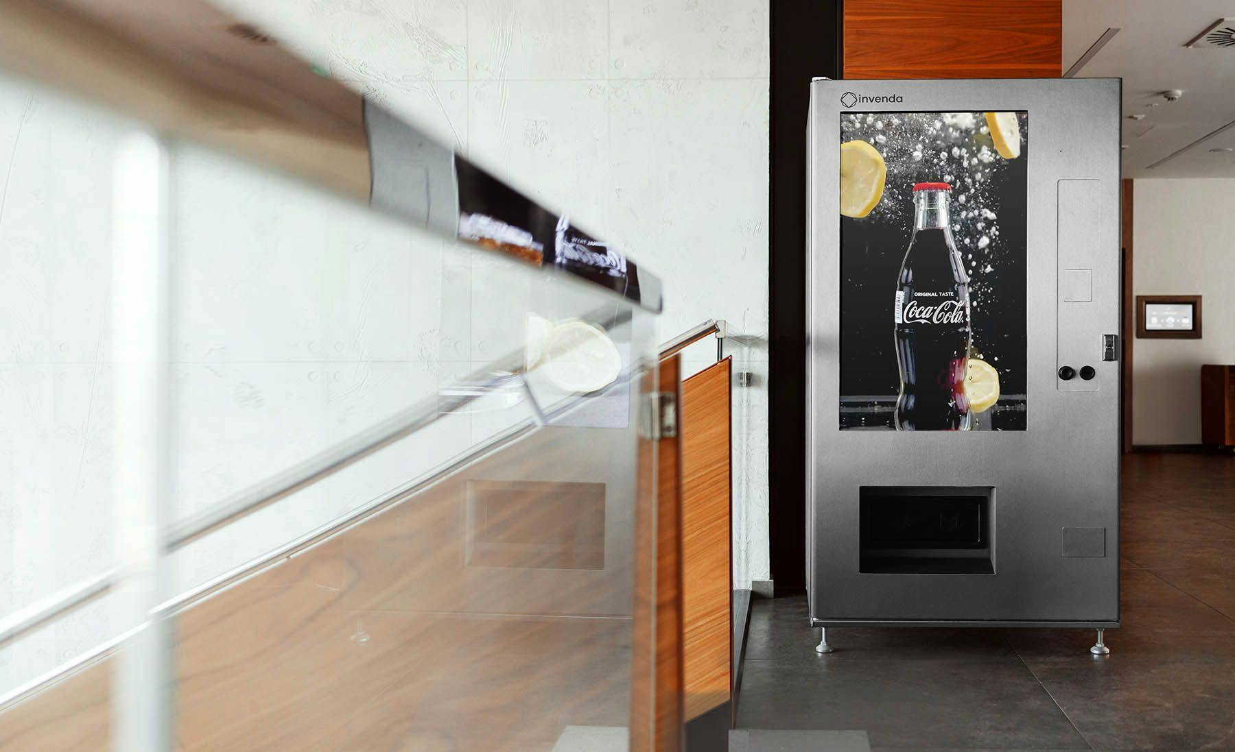 Smart vending machine showing a full screen Coca-Cola ad